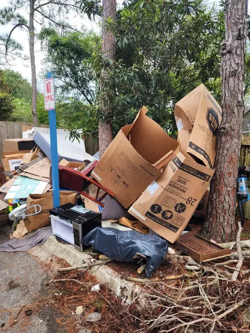 Large cardboard and bulk trash pile before recurring community pickup