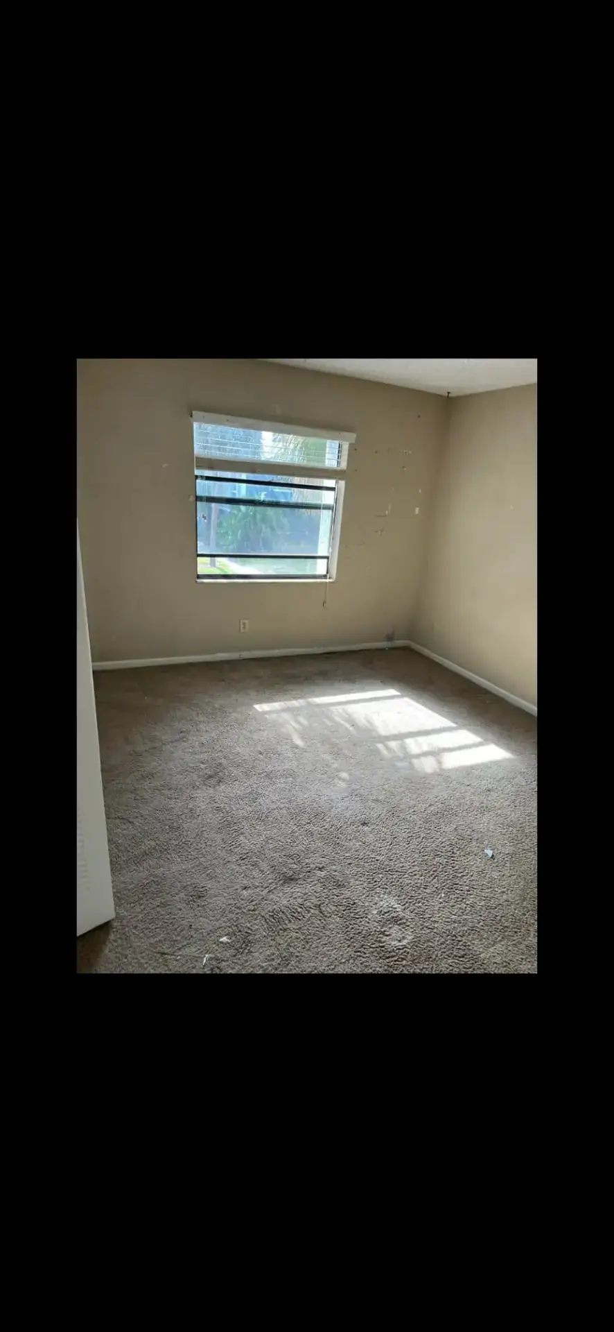 Empty apartment bedroom after a tenant turnover trash-out